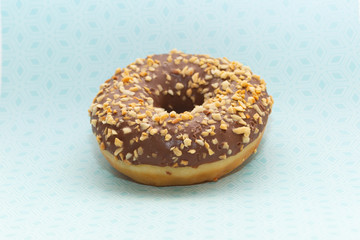 donut on blue with pattern background, close up view