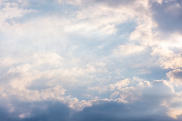 landscape sky with blue clouds and sunbeams at sunset. Background texture