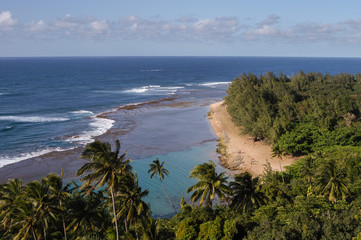 Golden sand Kee Beach and aquamarine colored lagoon from the Kalalau Trail in Haena State Park (end...