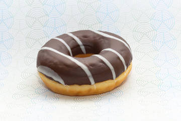 donut on gray with pattern background, close up view