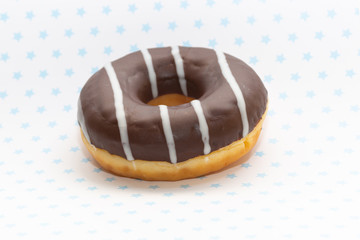 donut on white with blue stars background, close up view