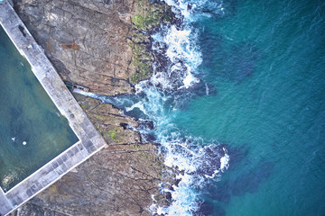 Newcastle ocean baths aerial drone view just after sunrise on overcast day