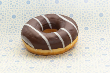 donut on gray with blue rings background, close up view