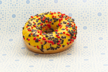 donut on gray with blue rings background, close up view