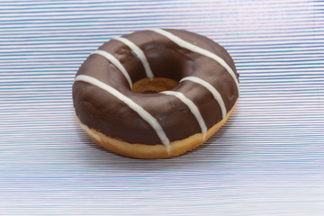donut on purple with lines background, close up view