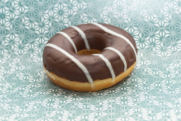 donut on gray with pattern background, close up view