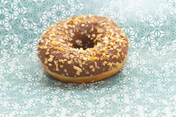 donut on gray with pattern background, close up view