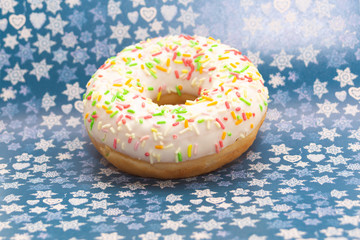 donut on purple with stars and hearts background, close up view
