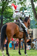 A mounted knight in shining armor readies his lance in preparation for combat in Turku, Finland. 