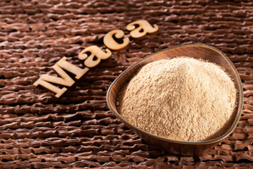 Dry Organic Maca Powder - Lepidium meyenii. Word maca in wooden letters