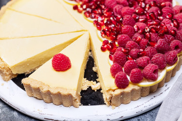 fresh french tart with raspberries on dark background