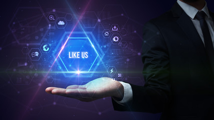 Man hand holding LIKE US inscription, social media concept