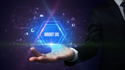 Man hand holding ABOUT US inscription, social media concept