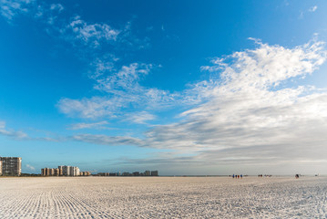 The wide open beach of Marco Island, Florida with a beautiful blue sky and white clouds