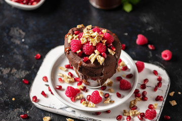 Raspberry mug cake in a glass on dark background
