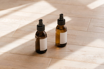 Cosmetic dark amber glass bottles on wooden table from above. Closeup, copyspace. Beauty blogging,...