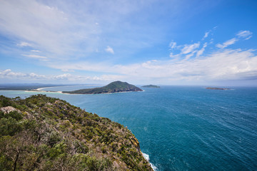 Obraz premium Port Stephens Tomaree National Park looking over islands with blue sky and blue water