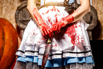 Bloodied knife in the hands of a girl.