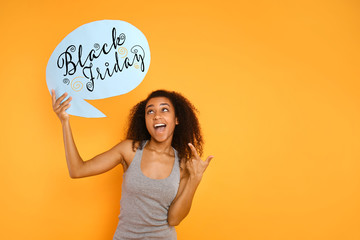 Portrait of beautiful African-American woman with blank speech bubble on color background