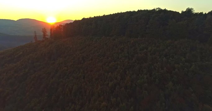 Autumn forest drone aerial shot at sunset. Overhead view of foliage trees in Hungary, Matra. Inspiring autumn season landscape panorama.