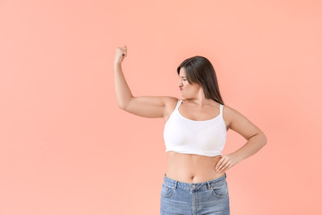 Portrait of body positive woman on color background