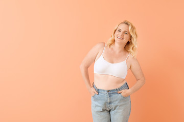 Portrait of mature body positive woman on color background