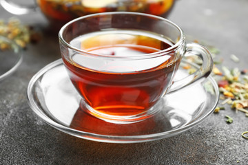 Cup of hot tea on grey background