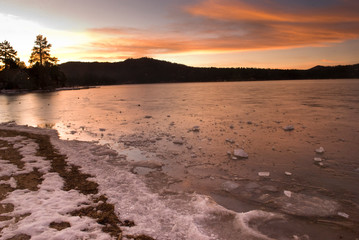 sunset over a frozen lake