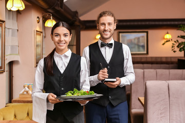 Portrait of young waiters in restaurant