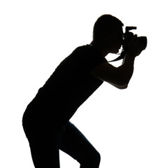 Silhouette of male photographer on white background