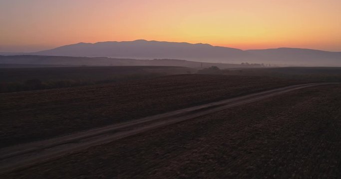 Aerial drone fly over northern Hungarian landscape at sunrise. Northern Matra mountains and hills.