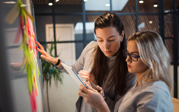 Teamwork, Project Management, Agile Methodology. Two Young Business Women In The Office Are Working On A Startup.