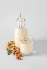 Tasty almond milk on white background