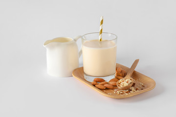 Tasty almond milk on white background