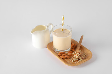 Tasty almond milk on white background