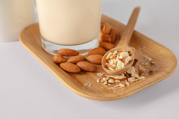 Tasty almond milk on white background