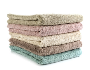 Stack of clean towels on white background
