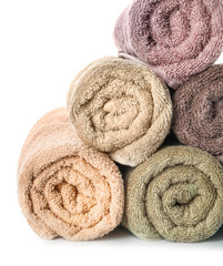 Rolled clean towels on white background