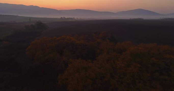 Aerial drone fly over northern Hungarian landscape at sunrise. Northern Matra mountains and hills.
