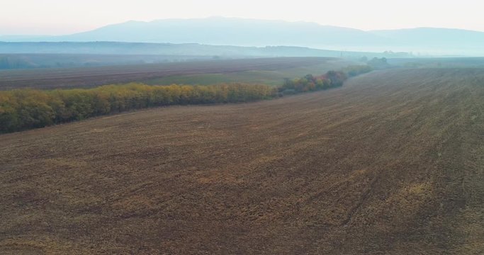 Aerial drone fly over northern Hungarian landscape at sunrise. Northern Matra mountains and hills.
