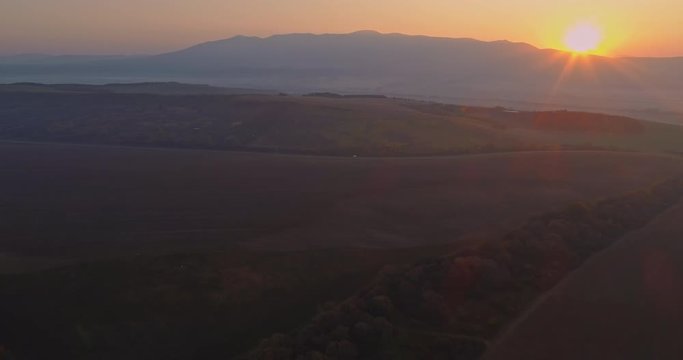 Aerial drone fly over northern Hungarian landscape at sunrise. Northern Matra mountains and hills.