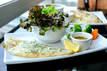 Grilled Pangasius with white cream sauce, serve with fresh salad.
