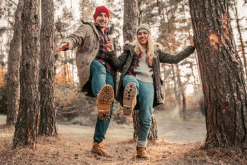Traveler couple show boots and having fun in highlands. Freedom and active lifestyle concept.