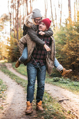Traveler couple in love so fun in the forest. Concept of trekking, adventure and seasonal vacation.