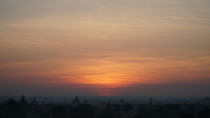 Naklejka premium Landscape Bagan Myanmar with Silhouettes of ancient Buddhist temples, Orange sky sunset