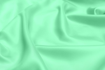 green satin fabric texture soft blur background