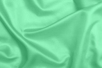 Fototapeta premium green satin fabric texture soft blur background
