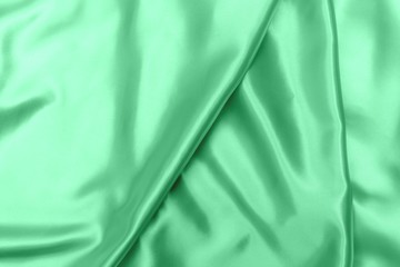 green satin fabric texture soft blur background