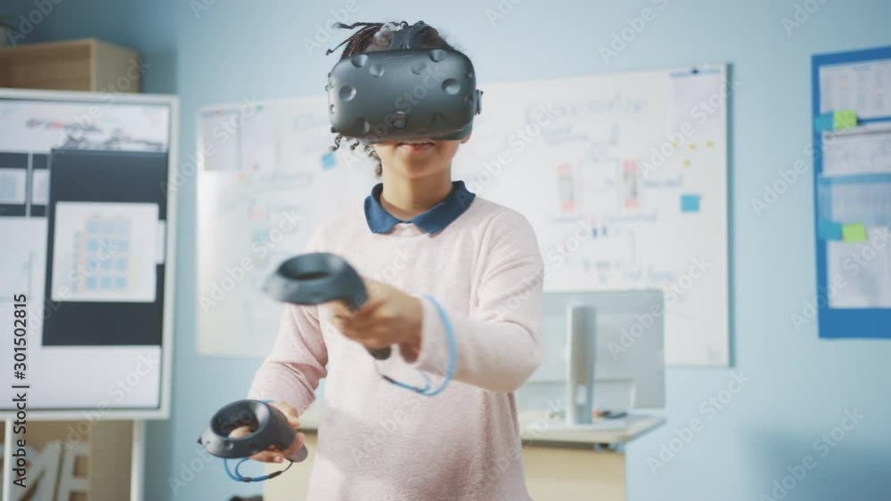 Poster elementary school computer science class: cute girl wearing augmented reality headset and using cont