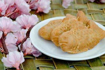 Taiyaki cakes in white dish with cherry blossom,Japanese confectionery